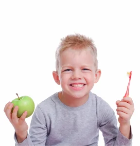 child with toothbrush and apple